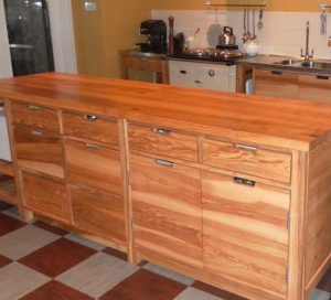 Ash island with push-me pull-you drawers with subtle cut handles.