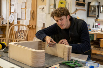 Student Carl Fink checks the details on his second project