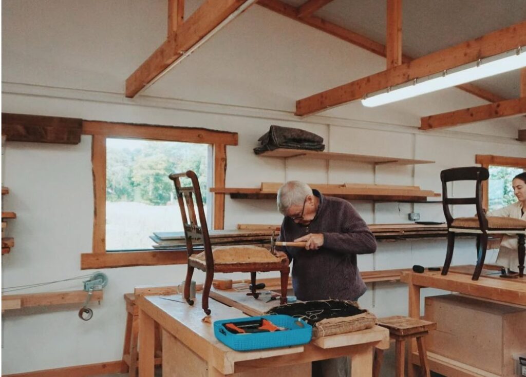 Man upholsters chair